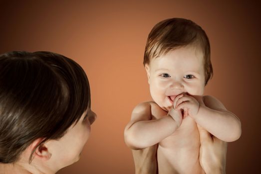 Cute portrait of mother and baby on background.