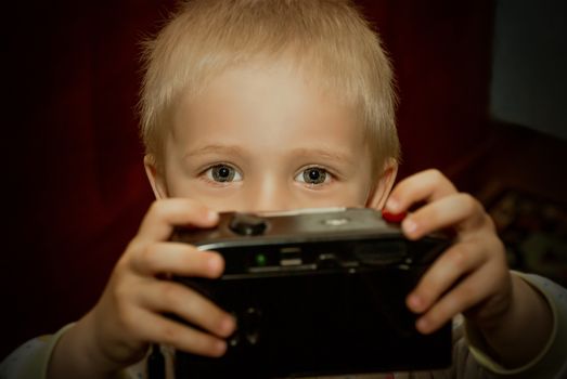 Young child with camera in hand.