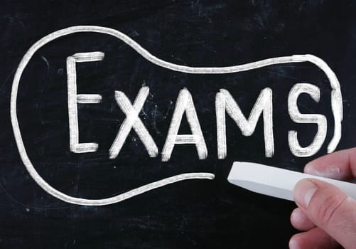 exams handwritten with chalk on a blackboard