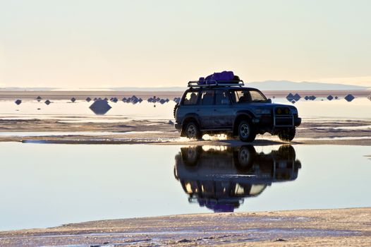 SALAR DE UYUNI, BOLIVIA - JULY 24: The car on the salt lake of Uyuni, July 24, 2011. Salar de Uyuni is located at an altitude of 4000 meters above sea level on the Altiplano plateau 