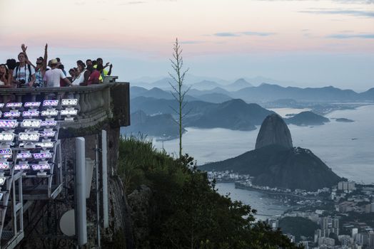 RIO DE JANEIRO, MARCH 3: Tourists are happy to see the first sunset after a week of rain and thunderstorms on the Corcovado Hill - march 3, 2013 in Rio de Janeiro, Brazil