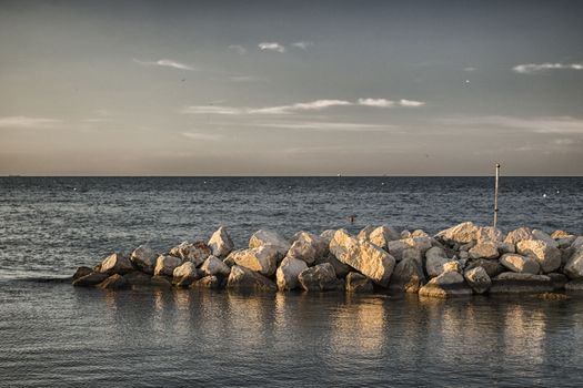 Rocks in front of the harbour channel of Cervia in Northern Italy on the Adriatic Sea