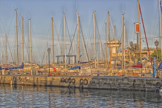 Sailing and engine boats moored in the harbour channel of Cervia in Northern Italy on the Adriatic Sea