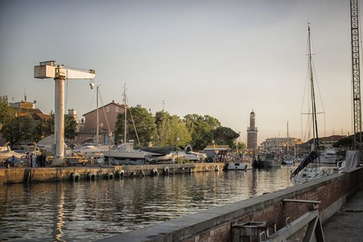 Sailing and engine boats moored in the harbour channel of Cervia in Northern Italy on the Adriatic Sea