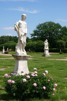 Summer park with marble sculptures                               
