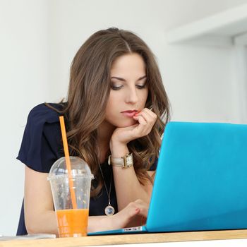 Beautiful, curly woman with laptop