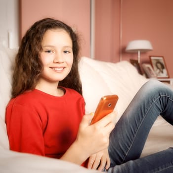 An image of a young girl with a mobile phone