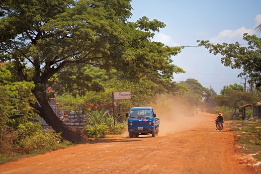 Truck on dusty road in Treak village, Siem Reap