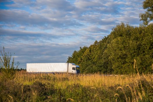 Trucks delivery cargo on the country road