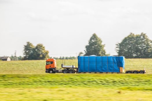 Truck delivery oversized cargo on the country road