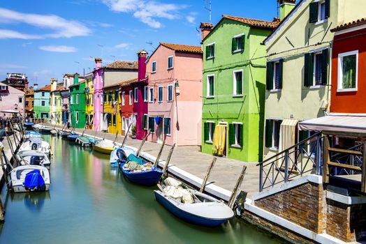 Colorful buildings in Burano island sunny street, Venise, Italy