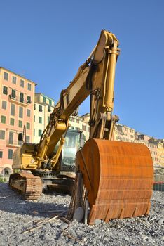 bulldozer stopped at a beach waiting for new digs