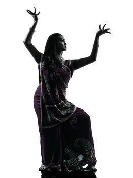 one indian woman dancer dancing in silhouette studio isolated on white background