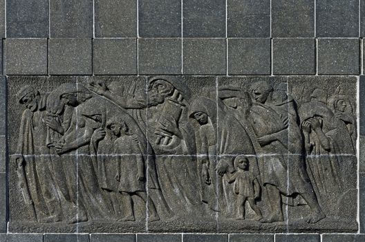 Back of the Nathan Rappaport's Warsaw Ghetto Monument, constructed in 1948 in commemoration of the Warsaw Ghetto Uprising in 1943. The granite relief shows a procession of deportees and symbolizes martyrdom and helplessness of the Jewish nation.