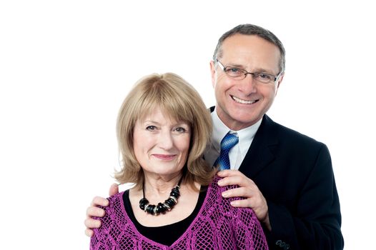 Loving senior couple posing over white background