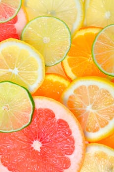Slices of various citrus fruits background