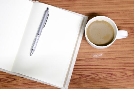 coffee and notebook on wood background concept coffee time