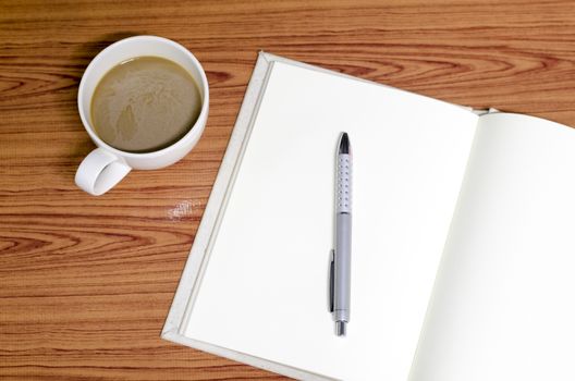 coffee and notebook on wood background concept coffee time