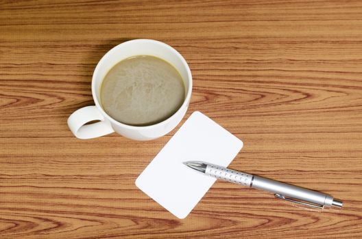 coffee cup and business card on wood background