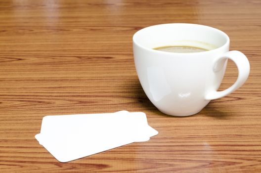 coffee cup and business card on wood background