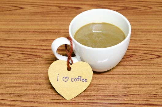 coffee cup with heart tag write I love coffee word on wood background