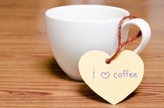 coffee cup with heart tag write I love coffee word on wood background