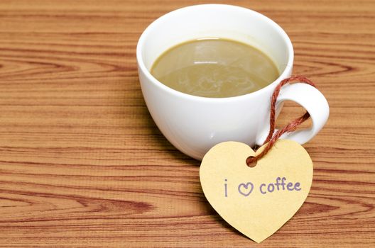 coffee cup with heart tag write I love coffee word on wood background