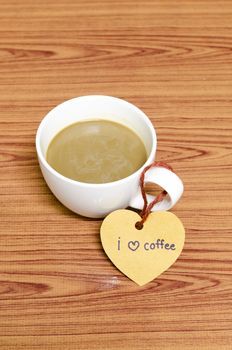 coffee cup with heart tag write I love coffee word on wood background