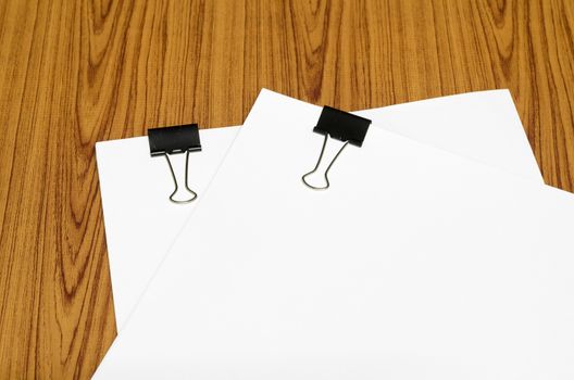 clip and paper on wood background