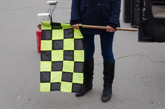 girl hand hold big checkered rally racing start flag