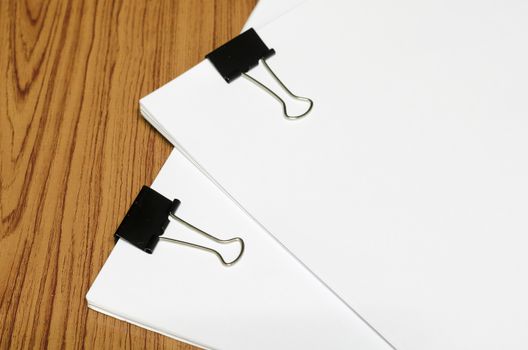 clip and paper on wood background