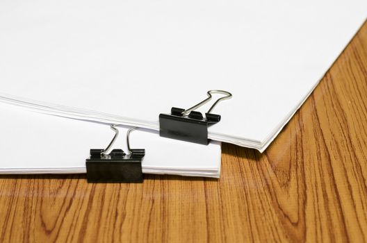 clip and paper on wood background