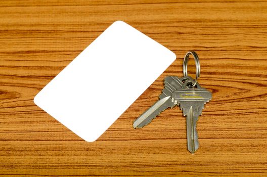 business card and keys on wood background