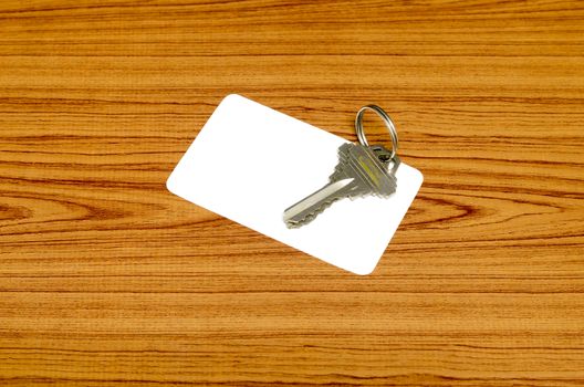 business card and keys on wood background