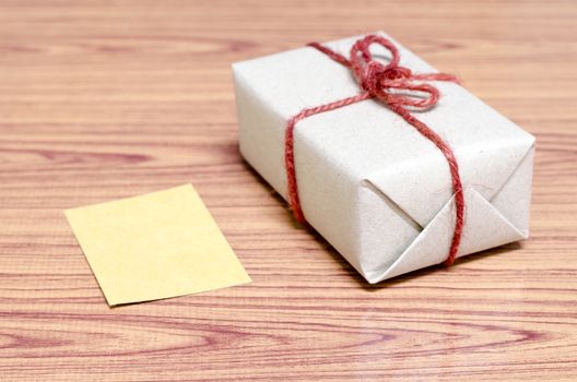 brown gift box and card on wood background