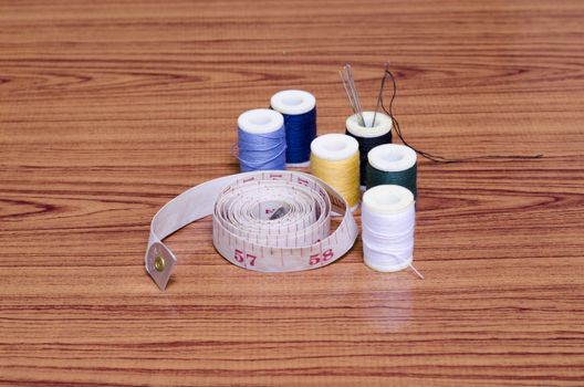 sewing kit on wood background
