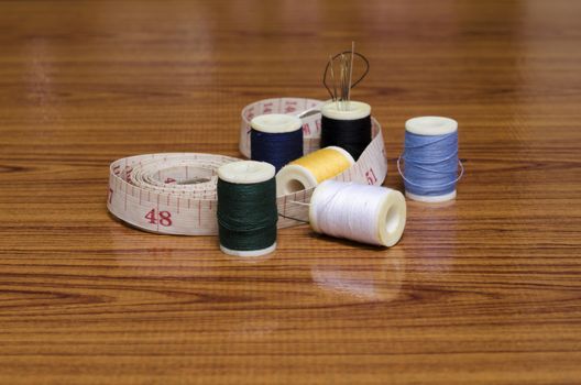 sewing kit on wood background
