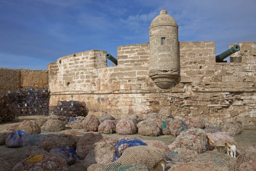 Fishing nets piled on the dockside in the historic fishing port of Essaouira in Morocco.
