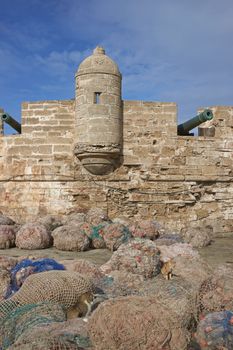 Fishing nets piled on the dockside in the historic fishing port of Essaouira in Morocco.