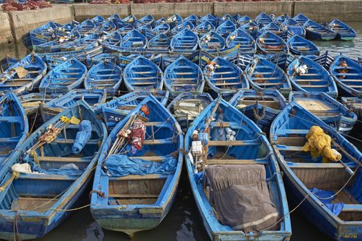 Small wooden fishing boats inside the historic harbour of Essaouira in Morocco.