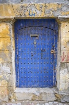 Traditional wooden door in the historic fishing port of Essaouira in Morocco.
