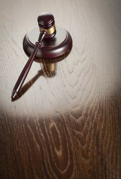 Dark Wooden Gavel Abstract on Reflective Table with Room for Text.