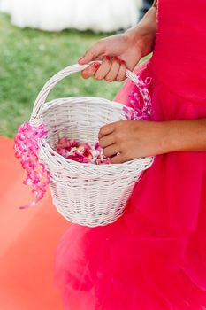 Flower girl with a basket of flower petals