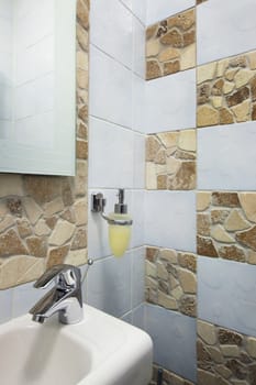 white sink and the metal tap in a bathroom