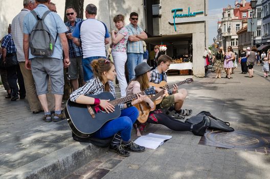 VILNIUS, LITHUANIA - MAY 18: street artist with guitar. Musician celebrate annual street music festival in Vilnius on May 18, 2013 in Vilnius.