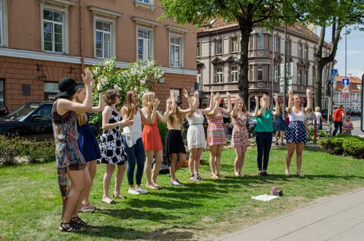 VILNIUS, LITHUANIA - MAY 18: young girl pop group performing with dance elements in the city park on May 18, 2013 in Vilnius.