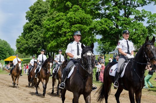 NIURONYS, LITHUANIA - JUNE 01: Ranger police riders show in annual city horse festival and people public audience on June 01, 2013 in Niuronys, Lithuania.