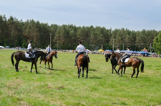 NIURONYS, LITHUANIA - JUNE 01: Mounted police horse riders demonstration perform in annual horse festival show on June 01, 2013 in Niuronys, Lithuania.