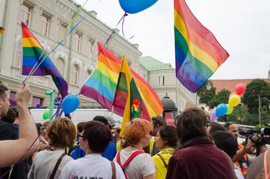 VILNIUS, LITHUANIA - JULY 27: colorfully dressed gay lesbian marchers holding flags balloons chanting slogans on July 27, 2013 in Vilnius.