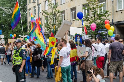 VILNIUS, LITHUANIA - JULY 27: traditional popular gay rainbow flags flying high on crowd on July 27, 2013 in Vilnius.